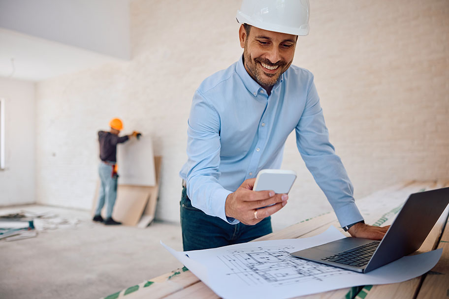 A service pro on a job site, checking his phone